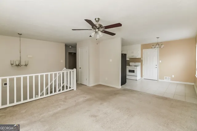an empty room with closet and windows