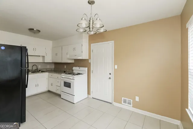a kitchen with stainless steel appliances a refrigerator sink and cabinets
