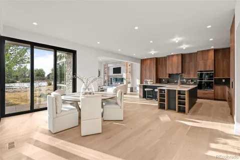 a kitchen with kitchen island granite countertop a sink and a stove