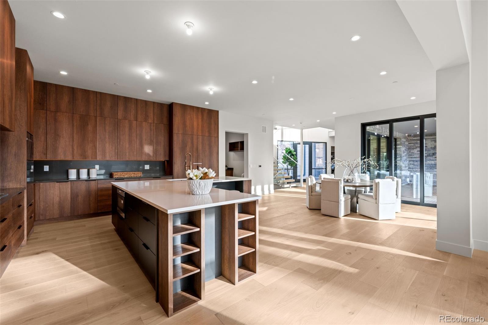 15 Sandy Lake Road Cherry Hills Village, CO 80113 - Photo 6 of 49 a large kitchen with stainless steel appliances granite countertop a large counter top and a stove