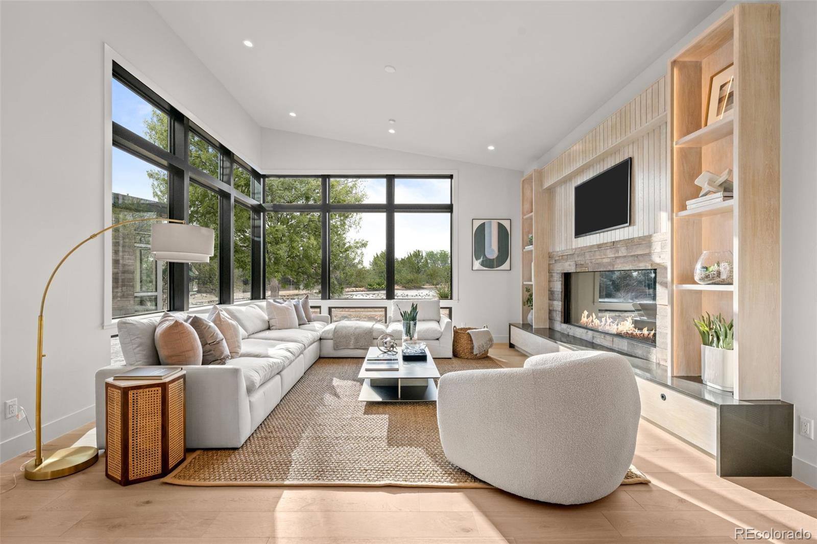 15 Sandy Lake Road Cherry Hills Village, CO 80113 - Photo 10 of 49 a living room with fireplace furniture and a large window
