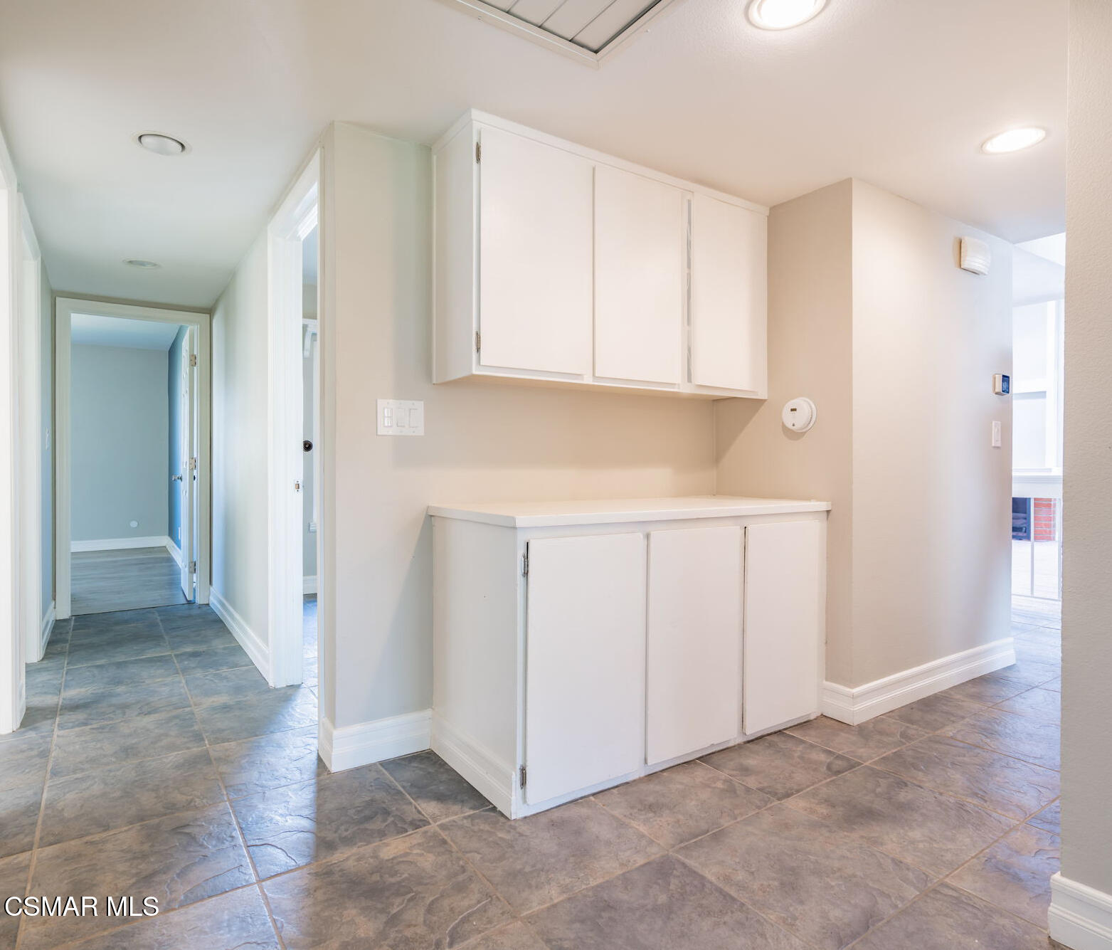 3648 Woodhaven Street Simi Valley, CA 93063 - Photo 13 of 30 a view of a kitchen with white cabinets