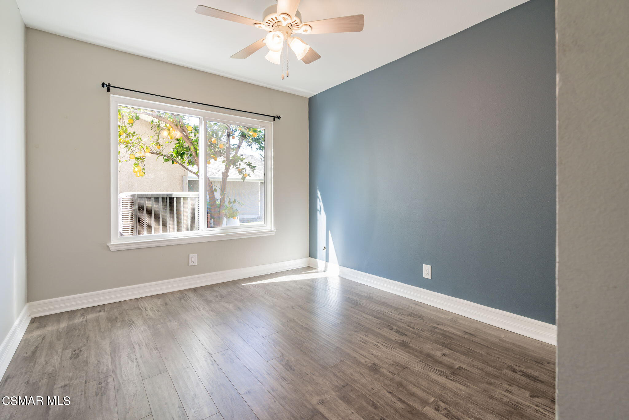 3648 Woodhaven Street Simi Valley, CA 93063 - Photo 21 of 30 a view of an empty room with wooden floor and a window