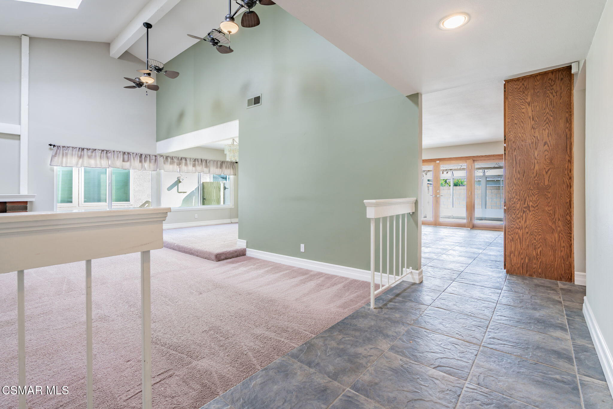 3648 Woodhaven Street Simi Valley, CA 93063 - Photo 4 of 30 a view of a hallway with a dining table & chairs