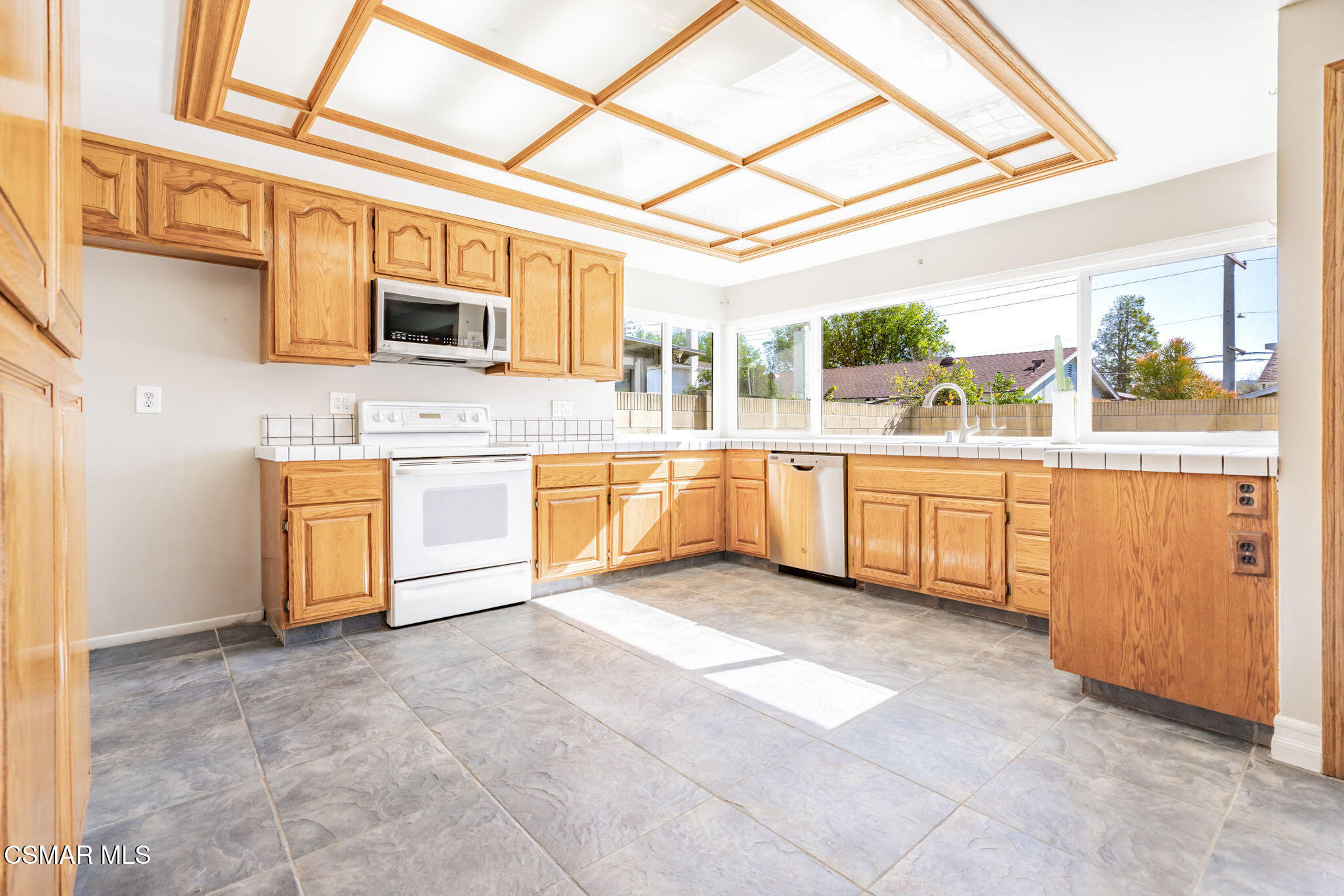 3648 Woodhaven Street Simi Valley, CA 93063 - Photo 8 of 30 a view of a kitchen with a sink and dishwasher cabinets