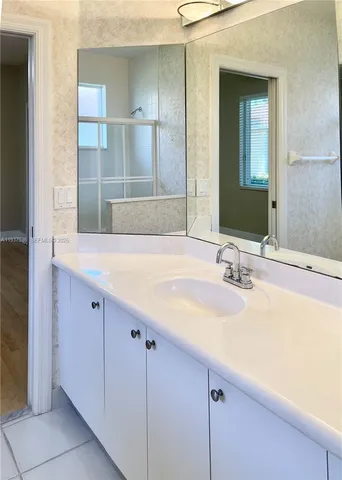 a bathroom with a sink and a mirror