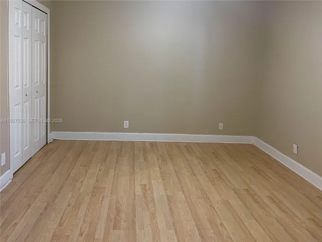 a view of a room with wooden floor