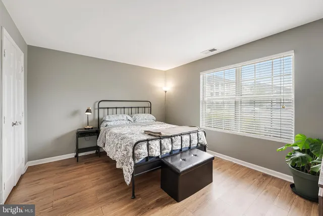 a bedroom with a bed and window