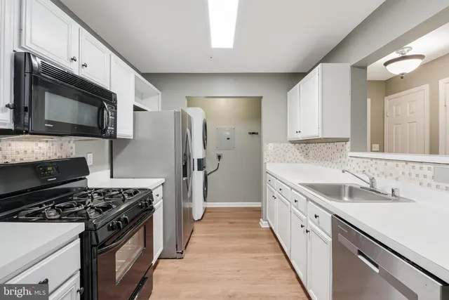 a kitchen with a sink stove and refrigerator