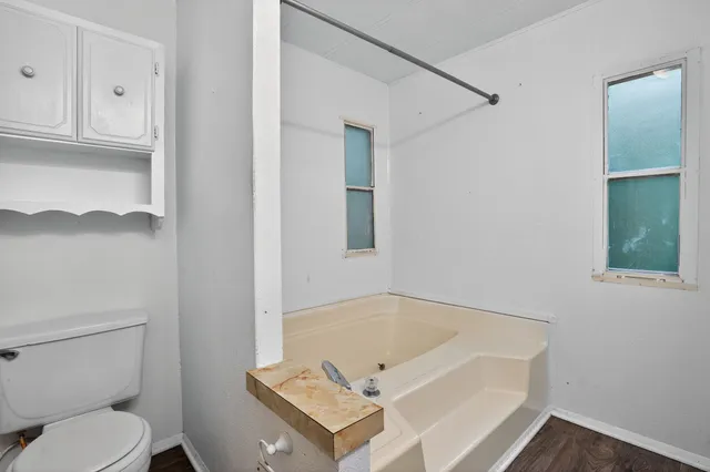 a bathroom with a bathtub and toilet
