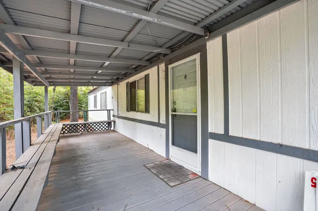 a view of a porch with wooden floor