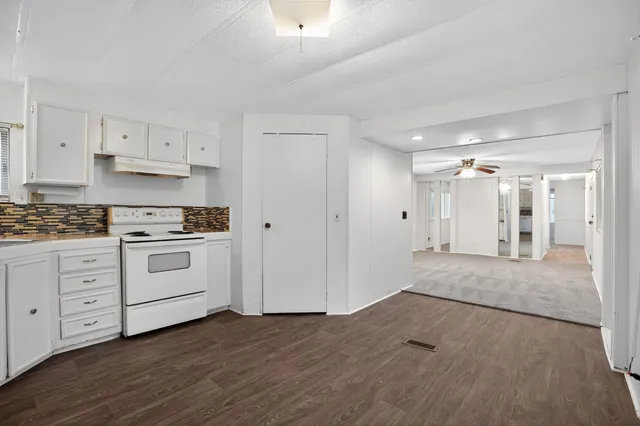 a view of kitchen with white cabinets stainless steel appliances