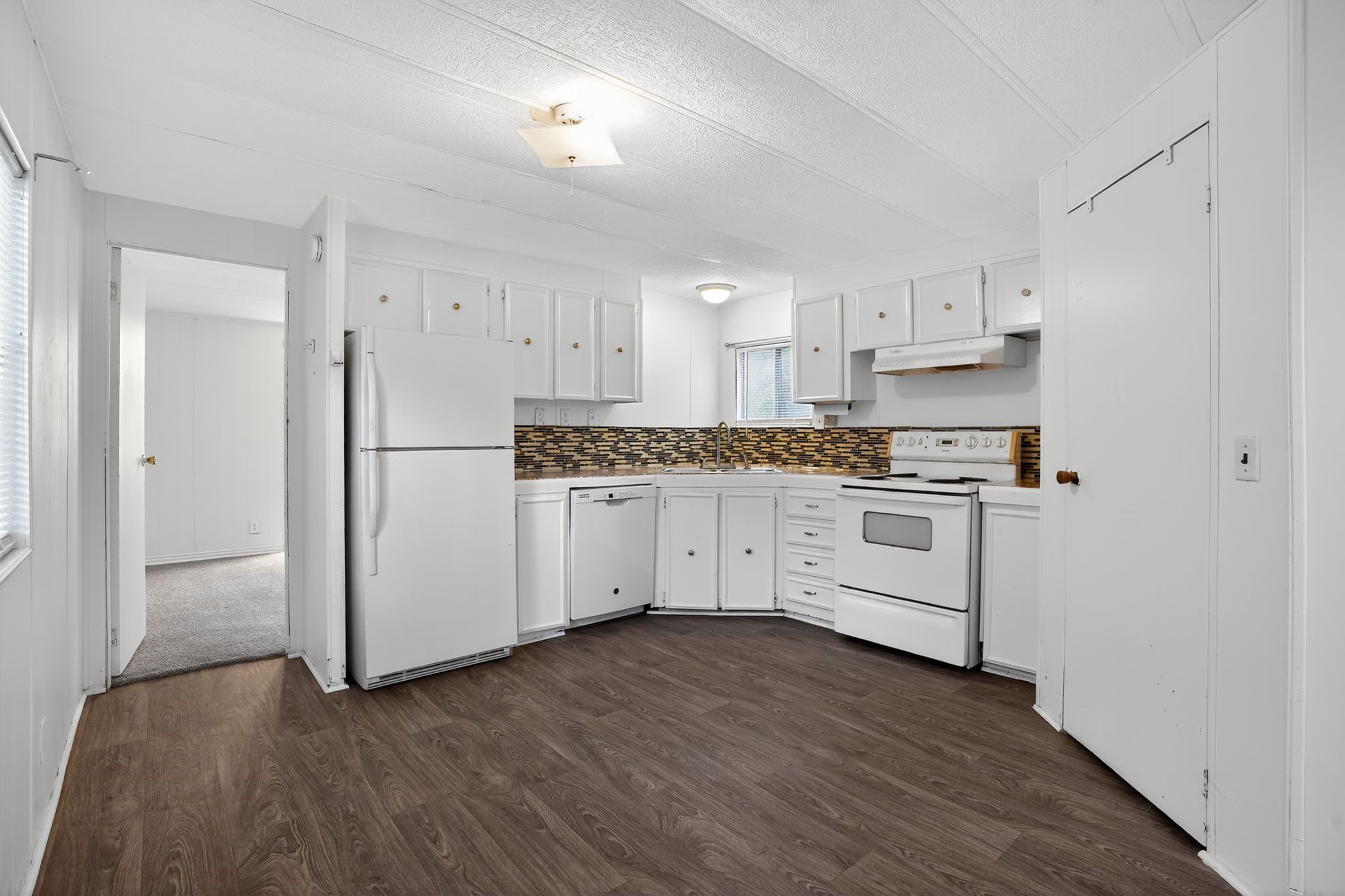 3 Meadowlark Trinity, TX 75862 - Photo 5 of 22 a kitchen with white cabinets and white appliances