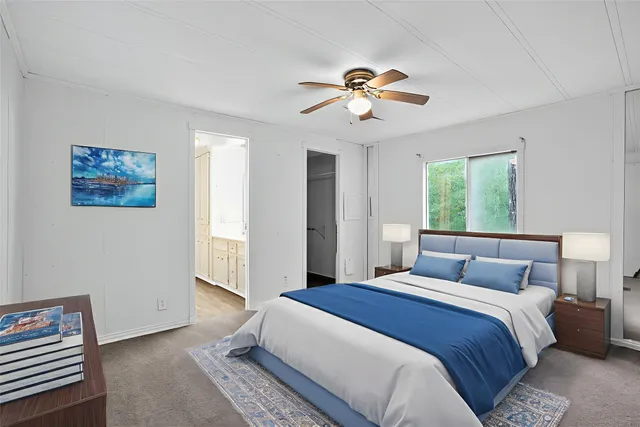 a bedroom with a large bed and a chandelier