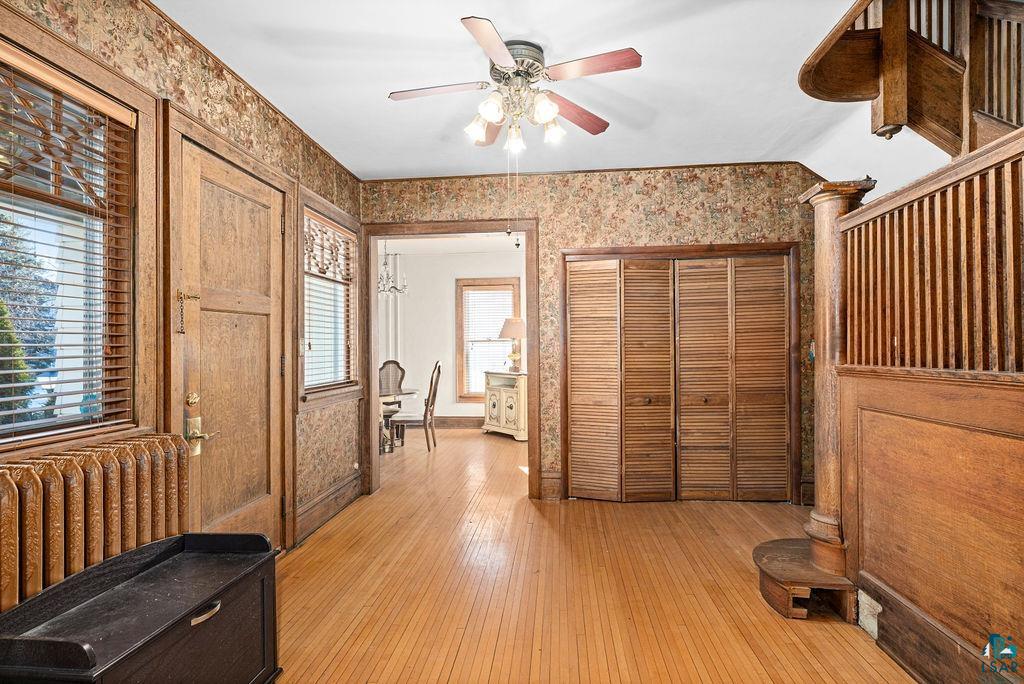 1505 North 19th Street Superior, WI 54880 - Photo 5 of 18 Foyer with light wood-style floors, radiator heating unit, and a ceiling fan