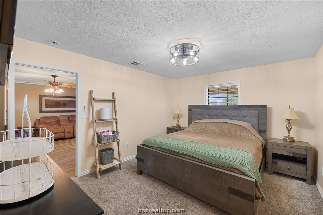 3540 Fisher Ranch Road Bryan, TX 77808 - Photo 13 of 36 a bedroom with a bed and furniture