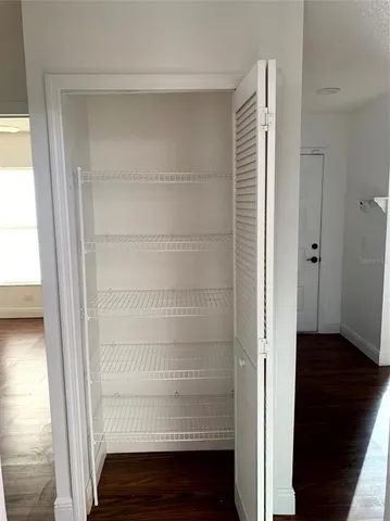 a view of walk in closet with empty racks