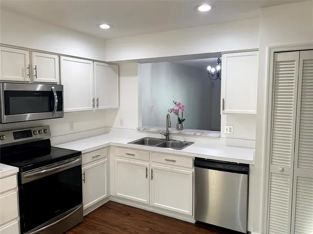 a kitchen with a sink and stainless steel appliances