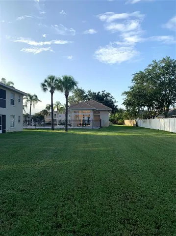 a view of house with garden space and trees