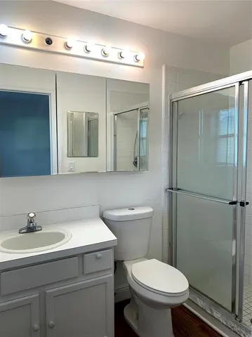 a bathroom with a sink toilet and shower