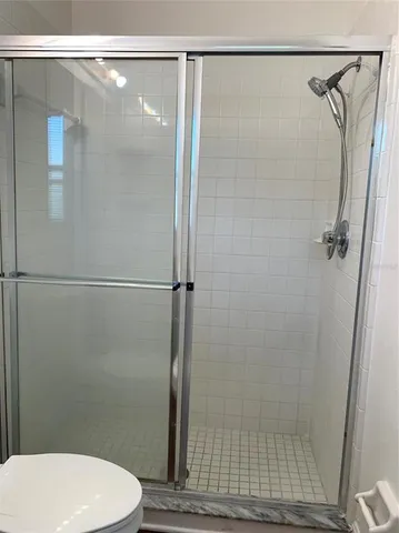a bathroom with a shower and a toilet