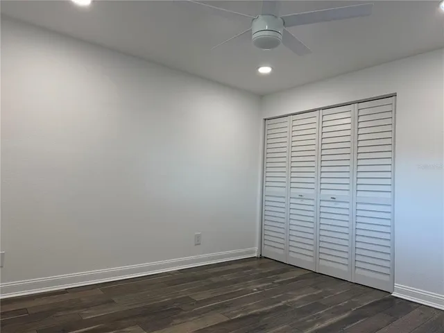 a view of a room with wooden floor and white walls