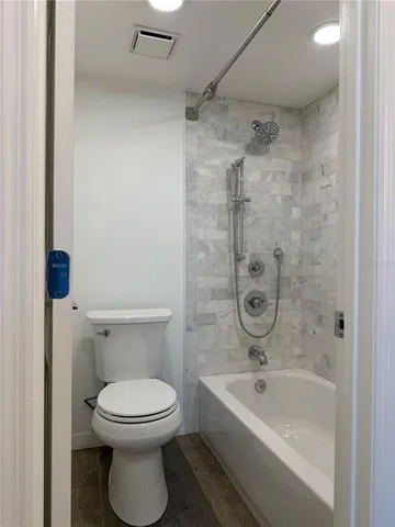 a bathroom with a toilet and a bathtub