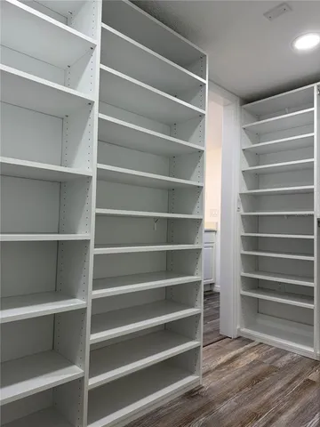 a view of walk in closet with empty racks