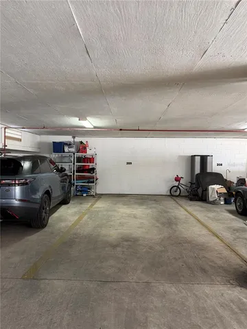 a view of parking garage with cars parked