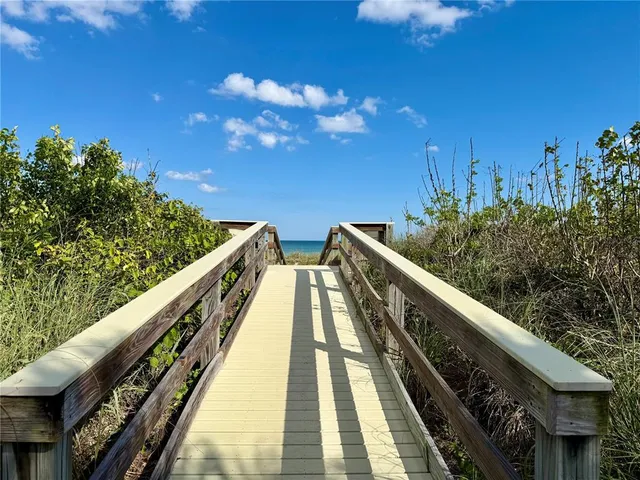 a view of balcony with wooden floor and fence