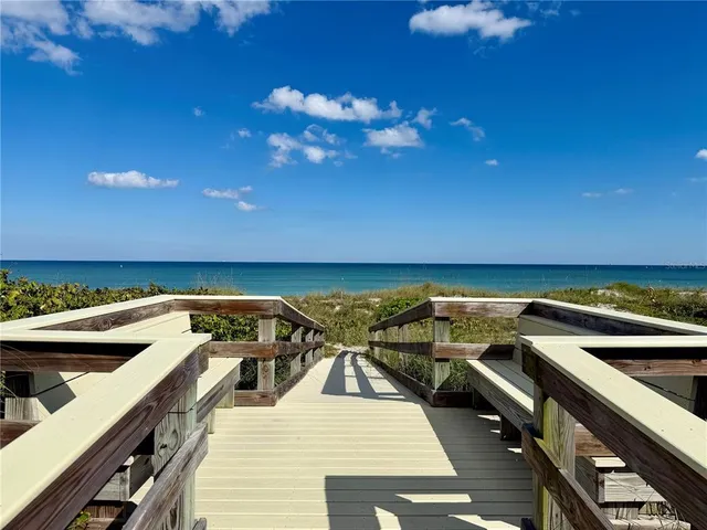 a view of a roof deck with dining table and chairs with wooden floor