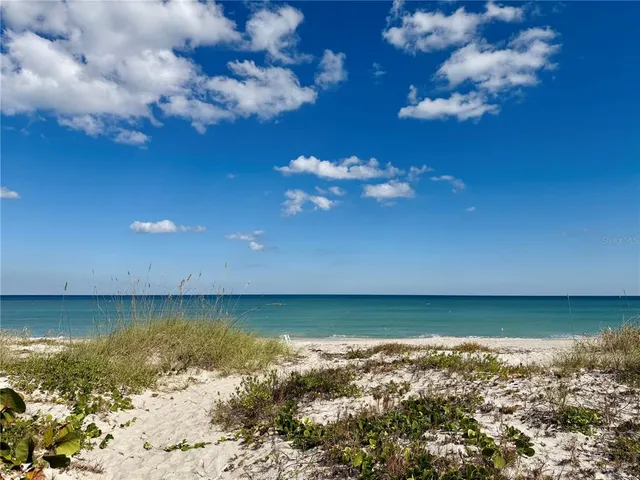 a view of a large body of water with a building in the background