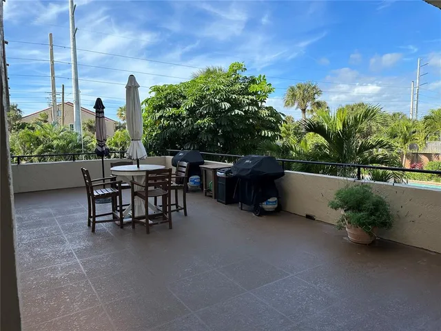 a view of a tables and chairs in back yard of the house