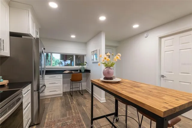 a dining room with kitchen island furniture a chandelier and kitchen view