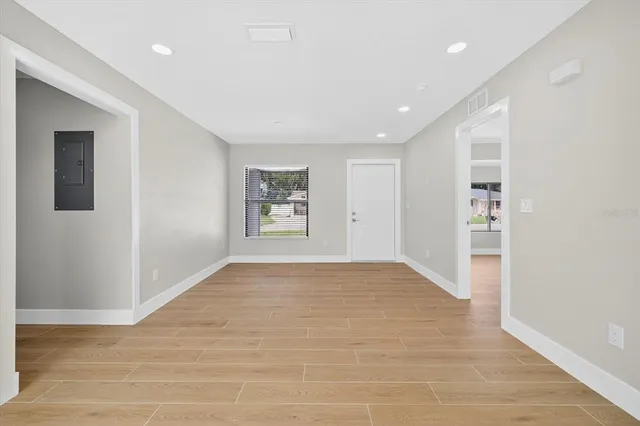 a view of an empty room with a kitchen