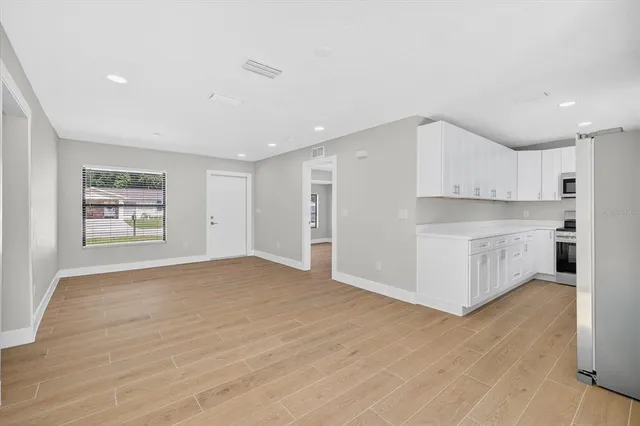 a kitchen with stainless steel appliances a sink and a refrigerator
