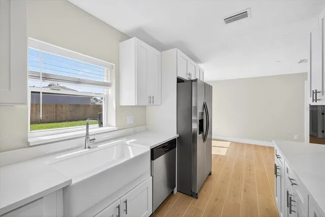 a kitchen with cabinets and stainless steel appliances