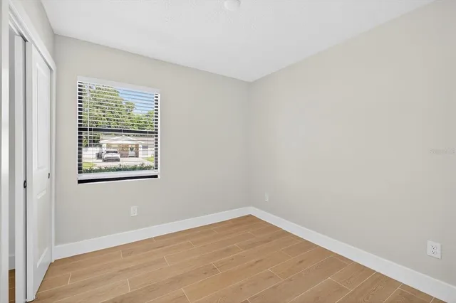 a view of a room with wooden floor and window