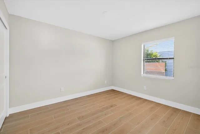 wooden floor in an empty room with a window