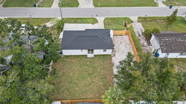 an aerial view of a house with a yard
