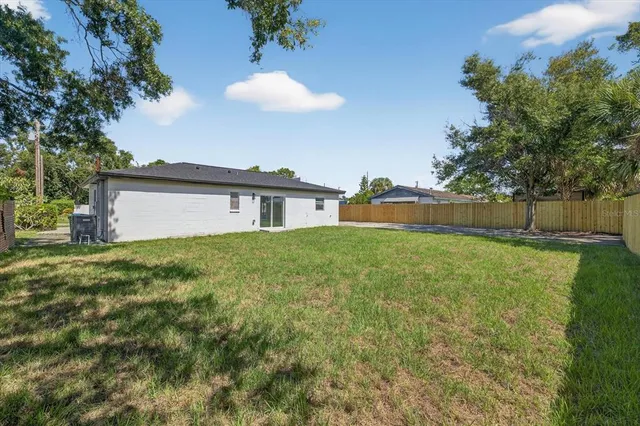 a backyard of a house with table and chairs
