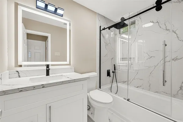 a bathroom with a sink a toilet and a bathtub