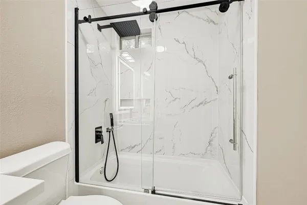 a bathroom with a glass shower door