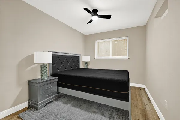 a living room with furniture and a ceiling fan