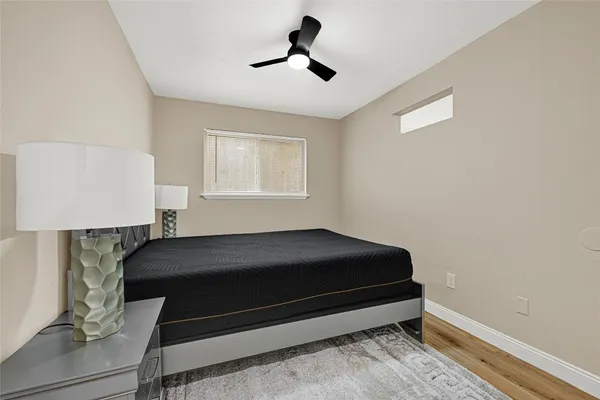 a bedroom with a bed and a ceiling fan