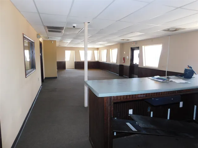 a kitchen with a table chairs and wooden floor