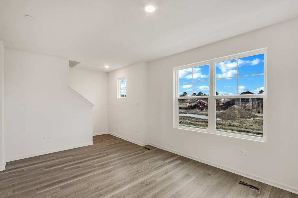 369 Bridgeview Court St. Charles, IL 60174 - Photo 15 of 44 a view of an empty room with wooden floor and a window
