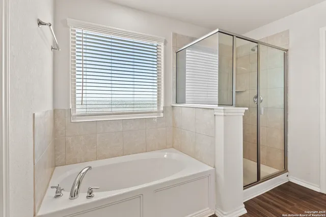 a bathroom with a bathtub and a shower