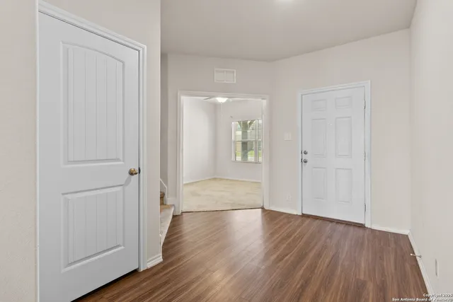 wooden floor with white walls