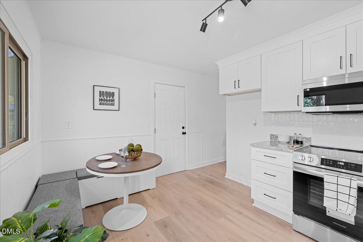 1406 Valley Road Garner, NC 27529 - Photo 16 of 39 a kitchen with stainless steel appliances a stove a white cabinets and a stove